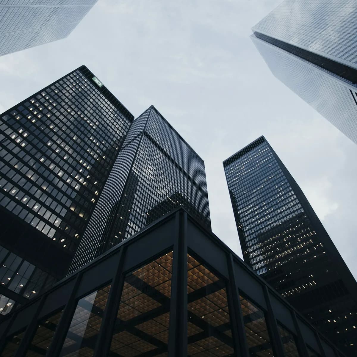 Glass towers of an international financial district, representing the markets 6767 Capital operates across